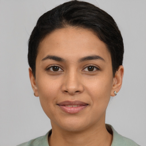 Joyful latino young-adult female with short  brown hair and brown eyes