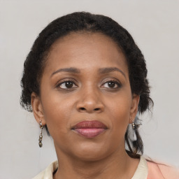 Joyful black adult female with medium  brown hair and brown eyes