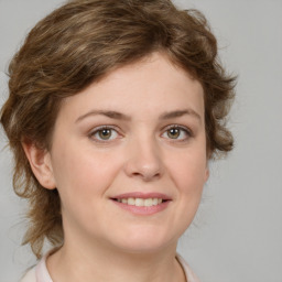 Joyful white young-adult female with medium  brown hair and green eyes