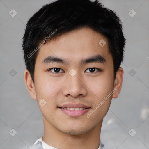 Joyful asian young-adult male with short  black hair and brown eyes