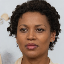 Joyful black adult female with short  brown hair and brown eyes