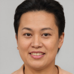 Joyful asian adult female with short  brown hair and brown eyes