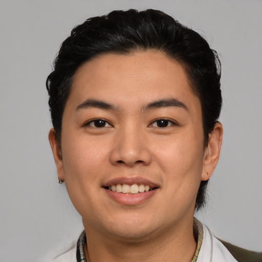 Joyful asian young-adult male with short  black hair and brown eyes