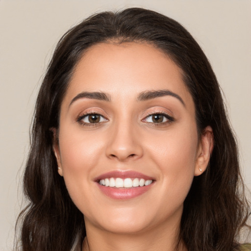 Joyful white young-adult female with long  brown hair and brown eyes