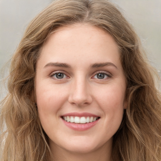 Joyful white young-adult female with long  brown hair and green eyes