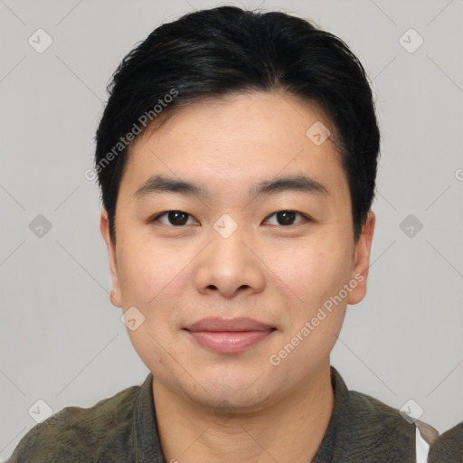 Joyful asian young-adult male with short  black hair and brown eyes