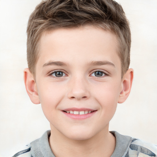 Joyful white child male with short  brown hair and grey eyes