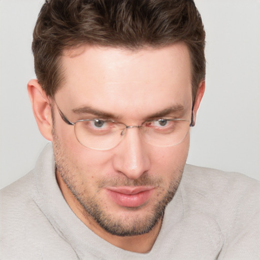 Joyful white young-adult male with short  brown hair and blue eyes