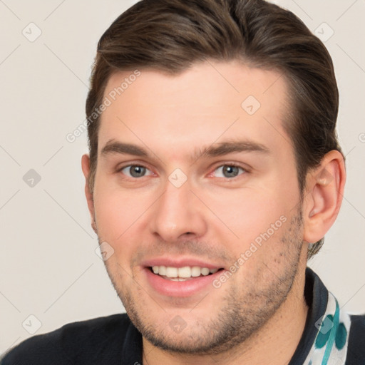 Joyful white young-adult male with short  brown hair and brown eyes