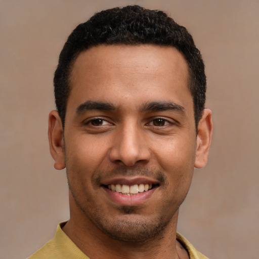 Joyful latino young-adult male with short  black hair and brown eyes