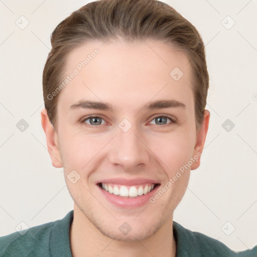 Joyful white young-adult male with short  brown hair and grey eyes