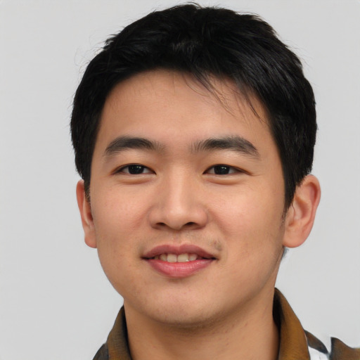 Joyful asian young-adult male with short  black hair and brown eyes