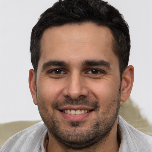 Joyful white young-adult male with short  brown hair and brown eyes