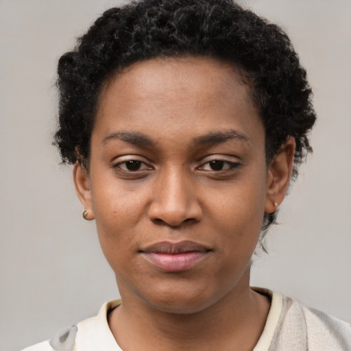 Joyful black young-adult female with short  brown hair and brown eyes