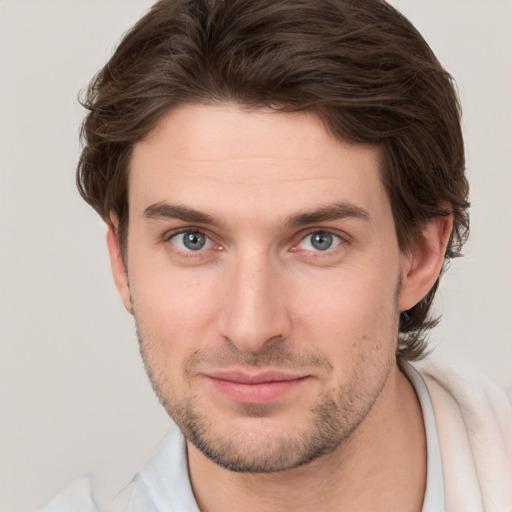 Joyful white young-adult male with short  brown hair and brown eyes