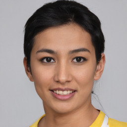 Joyful asian young-adult female with short  black hair and brown eyes