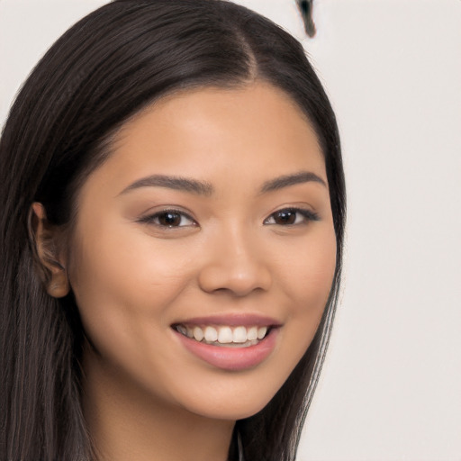 Joyful latino young-adult female with long  brown hair and brown eyes