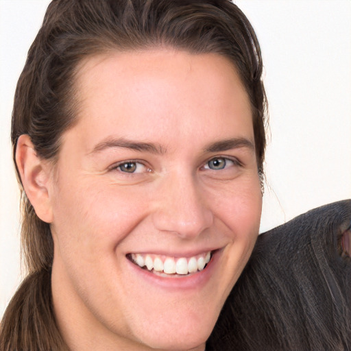 Joyful white young-adult female with long  brown hair and grey eyes