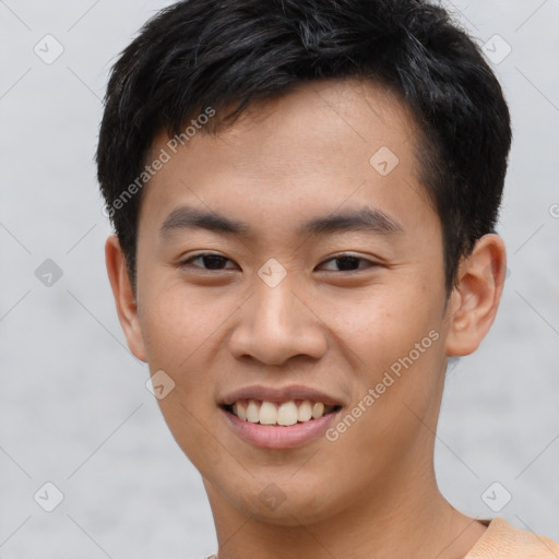 Joyful asian young-adult male with short  brown hair and brown eyes