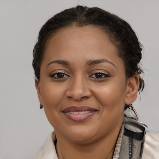 Joyful latino young-adult female with short  brown hair and brown eyes