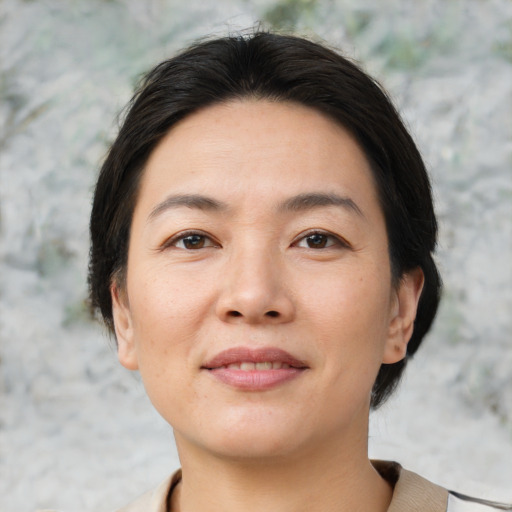 Joyful asian young-adult female with short  brown hair and brown eyes