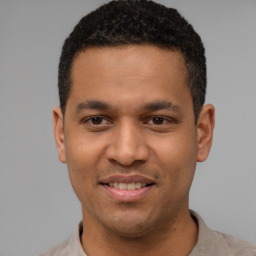 Joyful latino young-adult male with short  brown hair and brown eyes