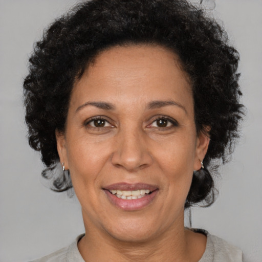 Joyful black adult female with short  brown hair and brown eyes