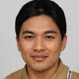 Joyful asian young-adult male with short  brown hair and brown eyes