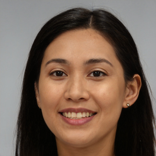 Joyful white young-adult female with long  brown hair and brown eyes