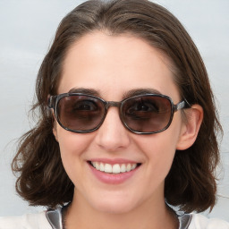 Joyful white young-adult female with medium  brown hair and blue eyes