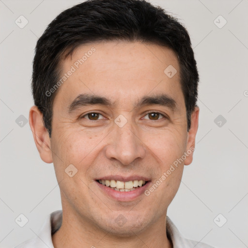 Joyful white adult male with short  black hair and brown eyes