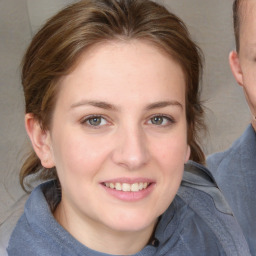 Joyful white young-adult female with medium  brown hair and blue eyes