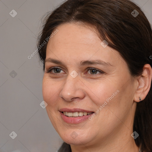 Joyful white adult female with medium  brown hair and brown eyes