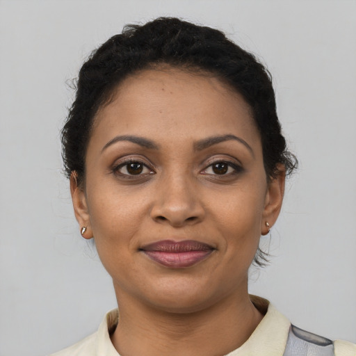 Joyful latino young-adult female with short  black hair and brown eyes
