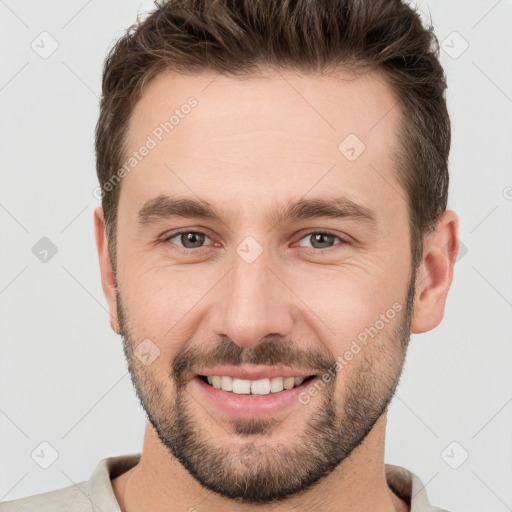 Joyful white young-adult male with short  brown hair and brown eyes