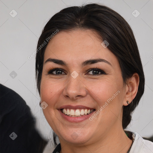 Joyful white adult female with medium  brown hair and brown eyes