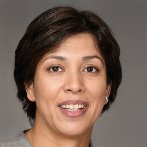 Joyful white adult female with medium  brown hair and brown eyes