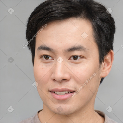 Joyful asian young-adult male with short  brown hair and brown eyes