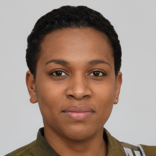 Joyful latino young-adult female with short  black hair and brown eyes