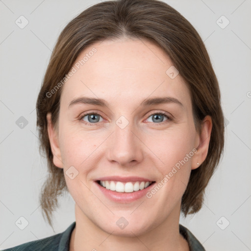 Joyful white young-adult female with medium  brown hair and grey eyes