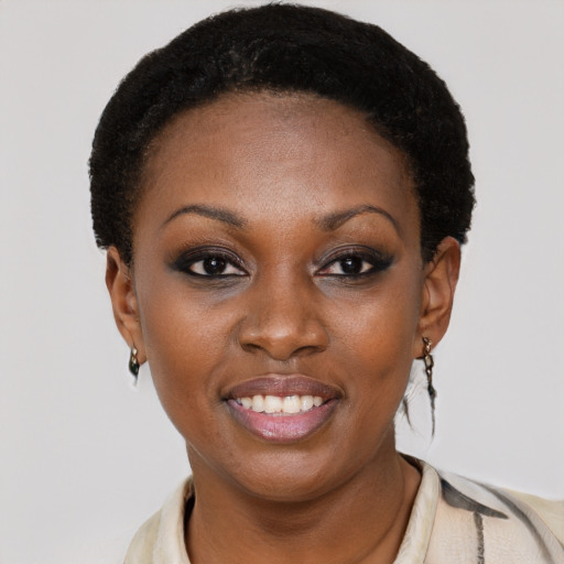 Joyful black young-adult female with short  black hair and brown eyes