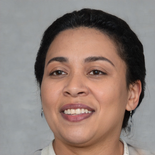 Joyful latino young-adult female with medium  black hair and brown eyes