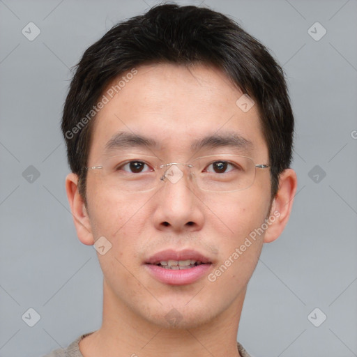 Joyful asian young-adult male with short  brown hair and brown eyes