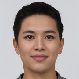 Joyful asian young-adult male with short  black hair and brown eyes