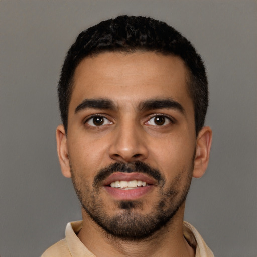 Joyful latino young-adult male with short  black hair and brown eyes