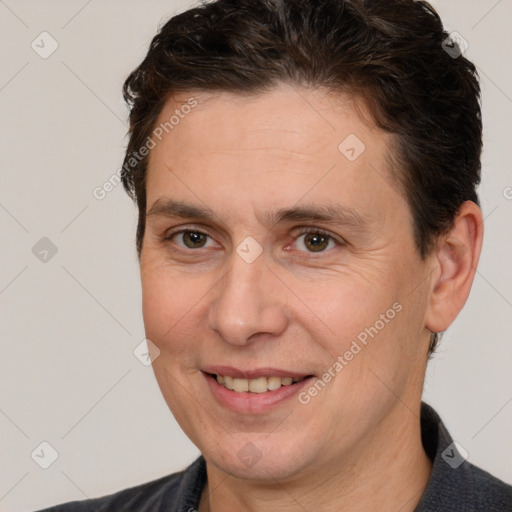 Joyful white adult male with short  brown hair and brown eyes