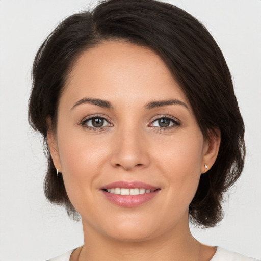 Joyful white young-adult female with medium  brown hair and brown eyes