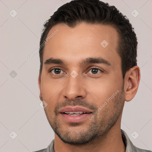 Joyful white young-adult male with short  brown hair and brown eyes