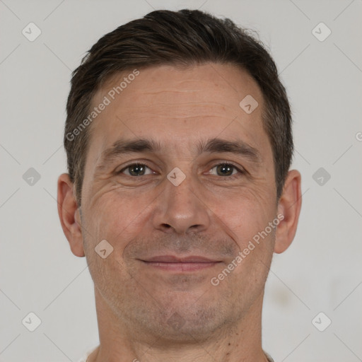 Joyful white adult male with short  brown hair and brown eyes