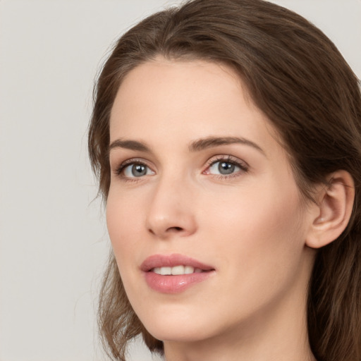 Joyful white young-adult female with long  brown hair and grey eyes